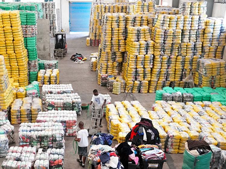 Aerial view of a wholesale ukay ukay warehouse with a forklift moving colour-sorted clothing bales