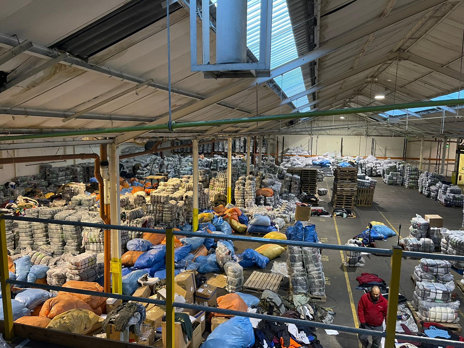 Mezzanine view of the Manila Fashion Dubai warehouse with pallets of graded bales and mixed sacks ready to load